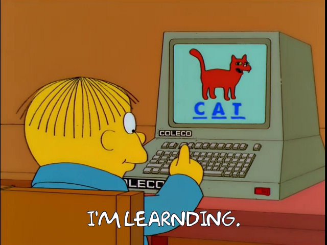 Ralph Wiggum at an old-fashioned Coleco computer. He has just finished spelling the word "CAT".